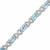 Thumbnail Image 0 of Oval Blue Topaz and Diamond Bracelet in Sterling Silver - 7.25"
