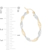 Thumbnail Image 1 of 30mm Diamond-Cut Twist Hoop Earrings in 14K Tube Hollow Two-Tone Gold